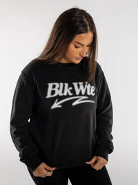 Female wearing a black sweatshirt with 'Blk Wte' logo on a white background