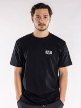 male model in a black t-shirt with a small BLKWTE logo on the left chest