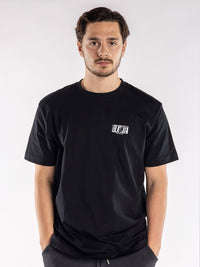 male model in a black t-shirt with a small BLKWTE logo on the left chest