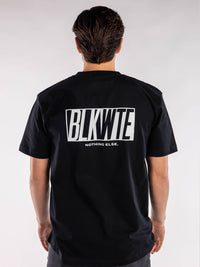 male model in a Black t-shirt with BLKWTE logo across the back in white 