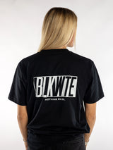 Female model in a Black t-shirt with BLKWTE logo across the back in white 