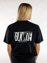 Female model in a Black t-shirt with BLKWTE logo across the back in white 
