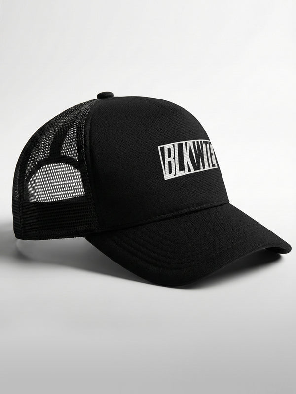 Black trucker cap with 'BLKWTE' logo on the front panel on a light gray background