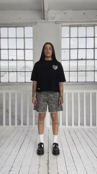 female model changing outfits from a white tee to a black tee