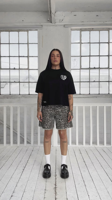 female model changing outfits from a white tee to a black tee